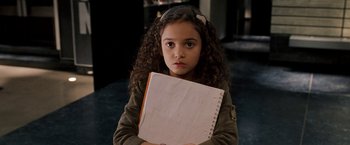 Movie still from “The Game Plan” (2007), directed by Andy Fickman – A young girl holding an open notebook in front of her face; Close Up shot, High angle