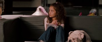 Movie still from “The Game Plan” (2007), directed by Andy Fickman – A young girl sitting on the floor with a pen in her hand; Medium shot, High angle