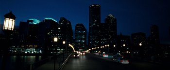 Movie still from “The Game Plan” (2007), directed by Andy Fickman – A view of a city street at night with cars driving down it; Extreme Wide shot, High angle