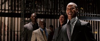 Movie still from “The Game Plan” (2007), directed by Andy Fickman – A group of men standing next to each other in suits; Medium shot, Low angle