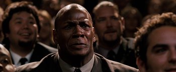 Movie still from “The Game Plan” (2007), directed by Andy Fickman – A person wearing a suit and tie; Close Up shot, Low angle