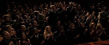 Movie still from “The Game Plan” (2007), directed by Andy Fickman – A group of people sitting in a room clapping; Wide shot, High angle