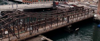 Movie still from “The Game Plan” (2007), directed by Andy Fickman – People are walking on a bridge over a river; Extreme Wide shot, High angle