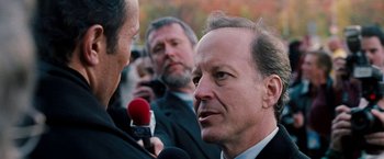 Movie still from “The Game Plan” (2007), directed by Andy Fickman – A man is being interviewed by a group of people; Close Up shot, Over the shoulder angle