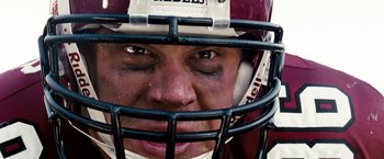 Movie still from “The Game Plan” (2007), directed by Andy Fickman – A person wearing a football helmet; Extreme Close Up shot, Overhead angle