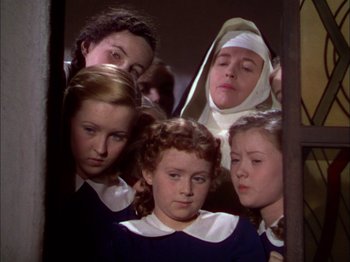 Movie still from “The Garden of Allah” (1936), directed by Richard Boleslawski – A group of young women standing next to each other; Medium shot, High angle