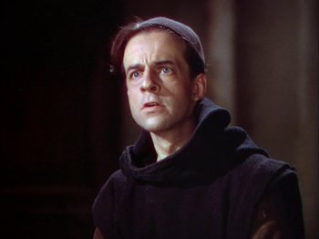 Movie still from “The Garden of Allah” (1936), directed by Richard Boleslawski – A man wearing a monk's outfit looking to his left; Close Up shot, Low angle