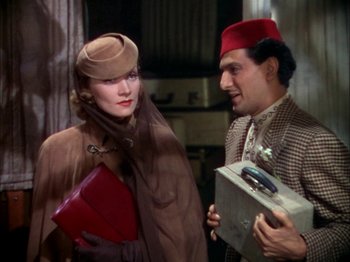 Movie still from “The Garden of Allah” (1936), directed by Richard Boleslawski – A man and a woman standing next to each other; Medium shot, Low angle