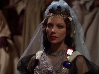 Movie still from “The Garden of Allah” (1936), directed by Richard Boleslawski – A woman wearing a wedding dress and a veil; Close Up shot, Over the shoulder angle