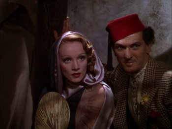 Movie still from “The Garden of Allah” (1936), directed by Richard Boleslawski – A man and a woman standing next to each other; Medium shot, Low angle