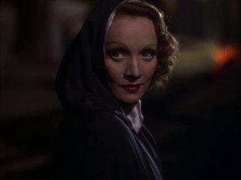 Movie still from “The Garden of Allah” (1936), directed by Richard Boleslawski – A person wearing a hooded jacket; Close Up shot, Low angle