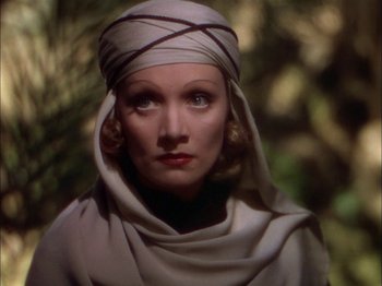 Movie still from “The Garden of Allah” (1936), directed by Richard Boleslawski – A person wearing a headscarf; Close Up shot, High angle