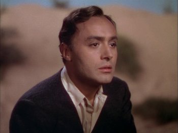 Movie still from “The Garden of Allah” (1936), directed by Richard Boleslawski – A person wearing a suit and tie; Close Up shot, Low angle