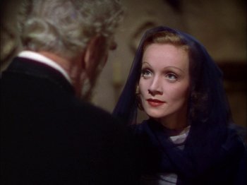 Movie still from “The Garden of Allah” (1936), directed by Richard Boleslawski – An older man and a young woman looking at each other; Close Up shot, Over the shoulder angle