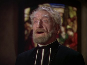 Movie still from “The Garden of Allah” (1936), directed by Richard Boleslawski – An old man with a beard and a mustache wearing a priest's outfit; Close Up shot, Low angle