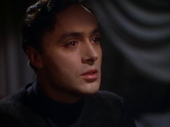 Movie still from “The Garden of Allah” (1936), directed by Richard Boleslawski – A person wearing a black shirt; Close Up shot, High angle