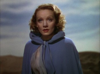 Movie still from “The Garden of Allah” (1936), directed by Richard Boleslawski – A person wearing a cape; Close Up shot, Low angle