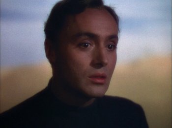 Movie still from “The Garden of Allah” (1936), directed by Richard Boleslawski – A man's face in front of a sky background; Close Up shot, Low angle