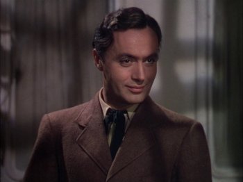 Movie still from “The Garden of Allah” (1936), directed by Richard Boleslawski – A person wearing a suit and tie; Close Up shot, Low angle