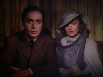 Movie still from “The Garden of Allah” (1936), directed by Richard Boleslawski – A man and a woman sitting next to each other; Close Up shot, Low angle