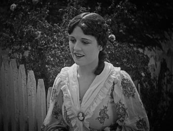 Movie still from “The General” (1926), directed by Buster Keaton – An old photo of a young woman in a dress; Close Up shot, High angle