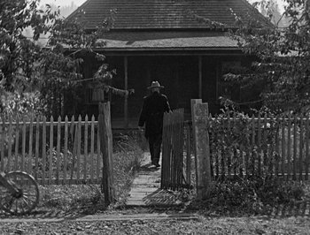 Movie still from “The General” (1926), directed by Buster Keaton – An old photo of a man walking down the street; Wide shot, Low angle