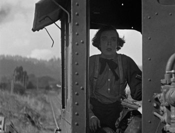 Movie still from “The General” (1926), directed by Buster Keaton – An old photo of a woman sitting in a train car; Medium shot, Low angle