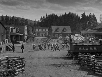 Movie still from “The General” (1926), directed by Buster Keaton – A black and white photo of a western town; Extreme Wide shot, High angle