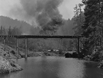Movie still from “The General” (1926), directed by Buster Keaton – A train is on a bridge over a body of water; Extreme Wide shot, High angle
