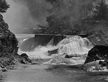 Movie still from “The General” (1926), directed by Buster Keaton – A black - and - white photo of a waterfall and a body of water; Extreme Wide shot, High angle
