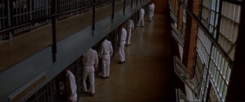 Movie still from “The Getaway” (1972), directed by Sam Peckinpah – A group of men in white suits walking in a room; Wide shot, High angle