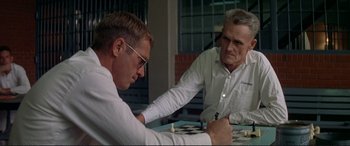Movie still from “The Getaway” (1972), directed by Sam Peckinpah – Two men are playing a game of chess in a room; Close Up shot, Over the shoulder angle