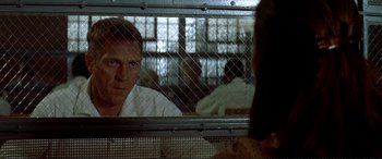 Movie still from “The Getaway” (1972), directed by Sam Peckinpah – A man looking at himself in a mirror; Close Up shot, Over the shoulder angle