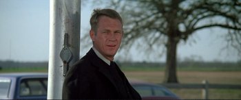 Movie still from “The Getaway” (1972), directed by Sam Peckinpah – A person wearing a suit and tie; Close Up shot, Low angle