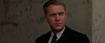 Movie still from “The Getaway” (1972), directed by Sam Peckinpah – A person wearing a suit and tie; Close Up shot, Low angle