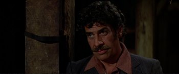 Movie still from “The Getaway” (1972), directed by Sam Peckinpah – A person with a mustache; Close Up shot, Over the shoulder angle