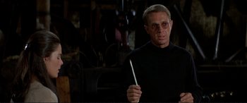 Movie still from “The Getaway” (1972), directed by Sam Peckinpah – A man holding a white stick in his hands; Close Up shot, Low angle