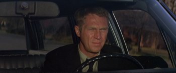 Movie still from “The Getaway” (1972), directed by Sam Peckinpah – A person sitting in a car; Close Up shot, Over the shoulder angle