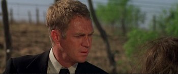 Movie still from “The Getaway” (1972), directed by Sam Peckinpah – A person wearing a suit and tie; Close Up shot, Over the shoulder angle