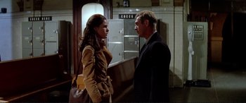 Movie still from “The Getaway” (1972), directed by Sam Peckinpah – A man and a woman standing next to each other in front of an oven; Medium shot, Low angle