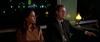 Movie still from “The Getaway” (1972), directed by Sam Peckinpah – A man and a woman sitting next to each other on a train; Medium shot, Low angle