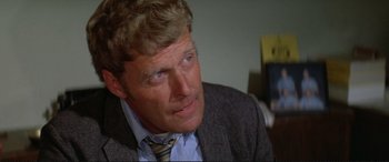 Movie still from “The Getaway” (1972), directed by Sam Peckinpah – A person wearing a suit and tie; Close Up shot, Over the shoulder angle