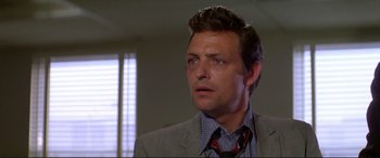 Movie still from “The Getaway” (1972), directed by Sam Peckinpah – A person wearing a suit and tie; Close Up shot, Low angle