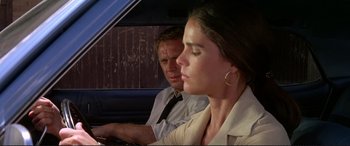 Movie still from “The Getaway” (1972), directed by Sam Peckinpah – A man and a woman sitting in the back of a car; Close Up shot, Low angle