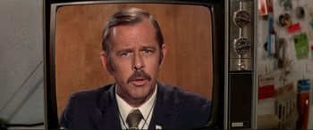 Movie still from “The Getaway” (1972), directed by Sam Peckinpah – An older man in a suit and a tie; Close Up shot, Low angle
