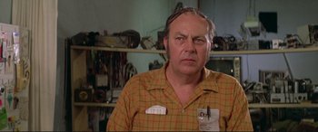 Movie still from “The Getaway” (1972), directed by Sam Peckinpah – An older man in a yellow and red plaid shirt; Close Up shot, Low angle