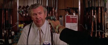 Movie still from “The Getaway” (1972), directed by Sam Peckinpah – An older man is being examined by a doctor; Close Up shot, Over the shoulder angle