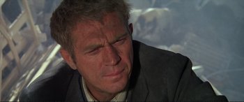 Movie still from “The Getaway” (1972), directed by Sam Peckinpah – An older man in a suit looking down at the ground; Close Up shot, Low angle