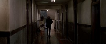 Movie still from “The Getaway” (1972), directed by Sam Peckinpah – A man and a woman walking down a hall way; Wide shot, High angle