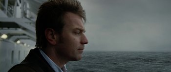Movie still from “The Ghost Writer” (2010), directed by Roman Polanski – A person looking at the ocean; Close Up shot, Over the shoulder angle